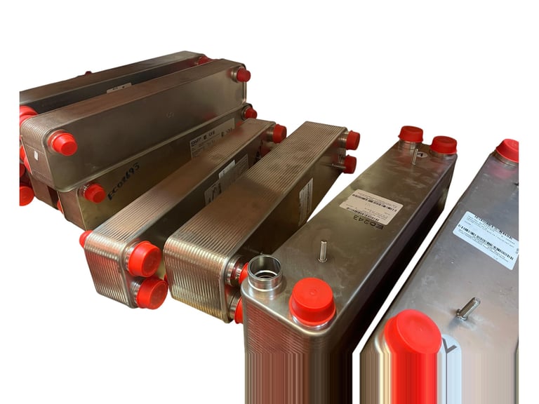 Four stainless steel heat exchanger units with red caps arranged in a row, showing industrial cooling or heating equipment